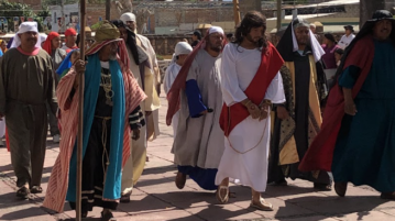 Crowds follow the reenactment of The Stations of the Cross