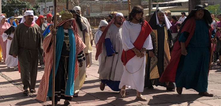 Crowds follow the reenactment of The Stations of the Cross