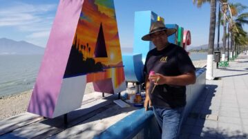 Artist Bruno Mariscal touching up Ajijic letters